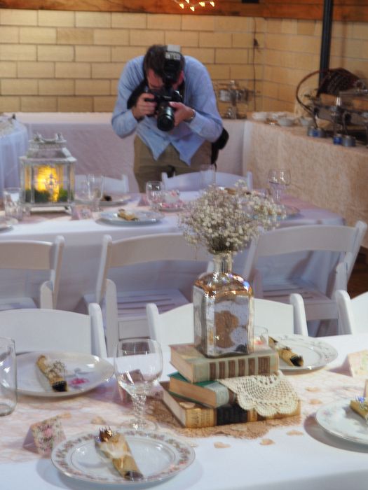 A photographer takes pictures of the place settings